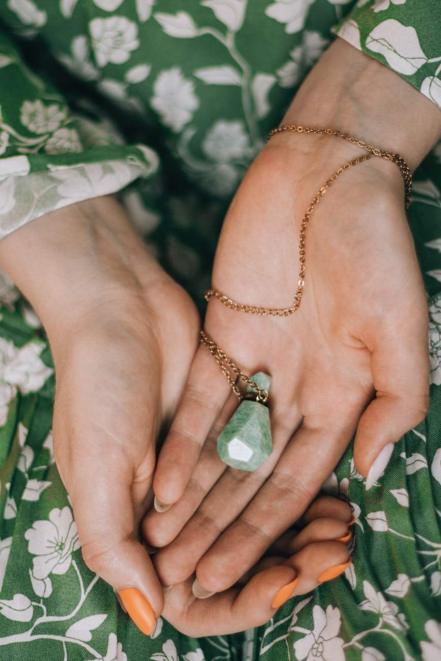 woman hands holding crystal bottle jewelry